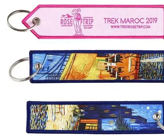 Woven jet tag keychains with metal eyelets and rings