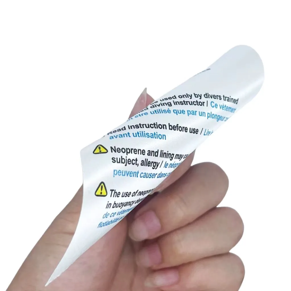 Flexible printed warning and instruction label held in hand