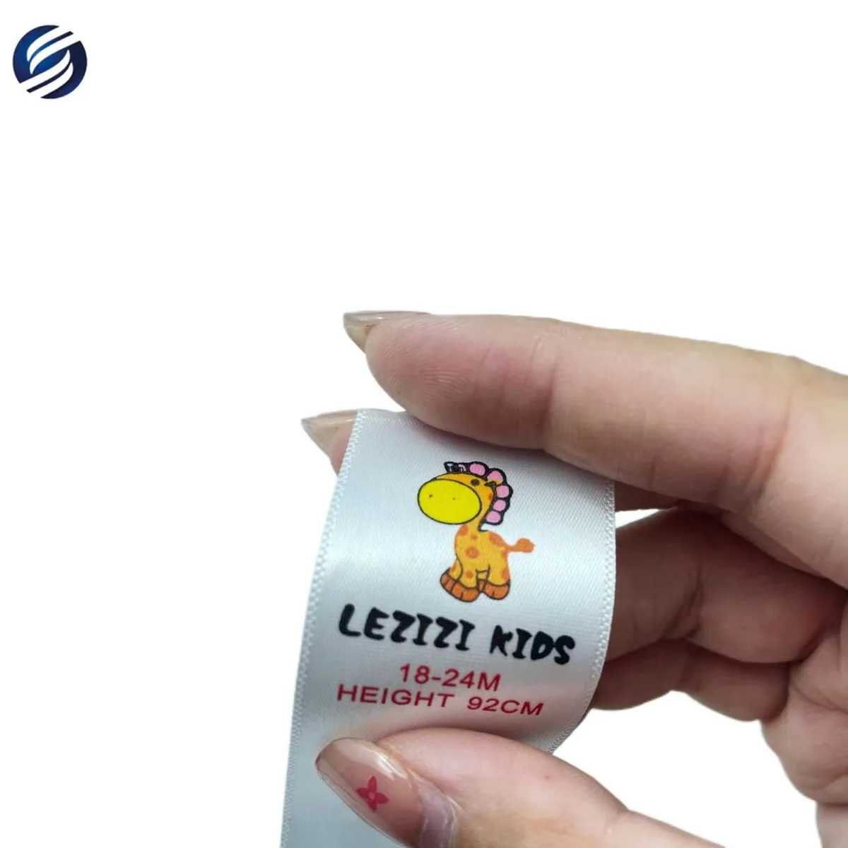 Soft white satin kidswear label with a full-color giraffe design