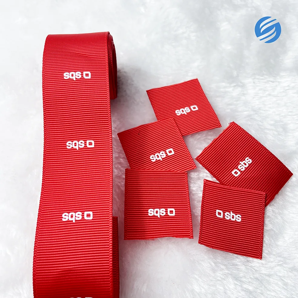 Red folded garment labels with white logo printing