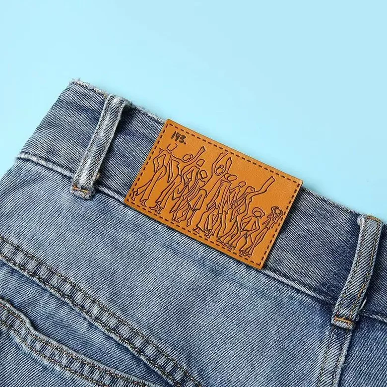 Debossed leather patch on a denim waistband