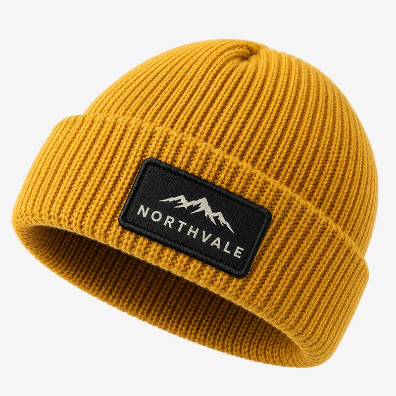 Woven Northvale mountain patch on a mustard cuffed beanie