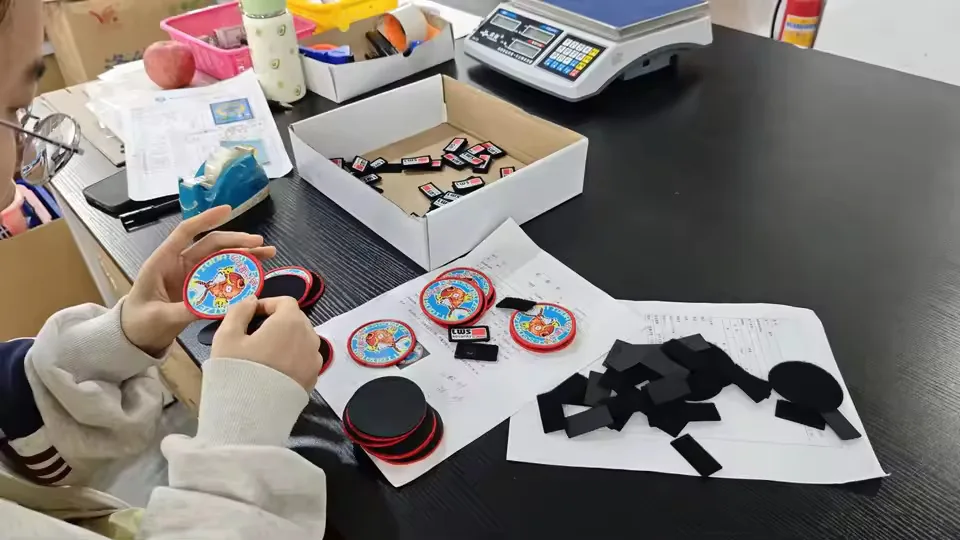 Operator comparing finished patches with approved sample details