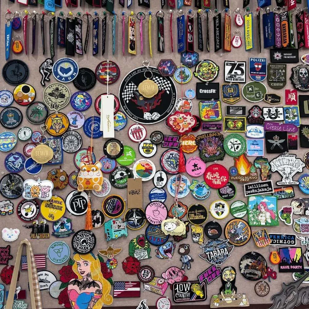 Real SAIM Label sample wall with patches and fabric keychains