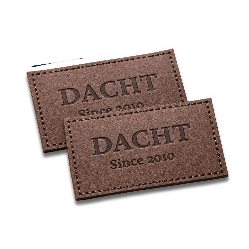 Pair of brown debossed leather garment patches with stitched borders