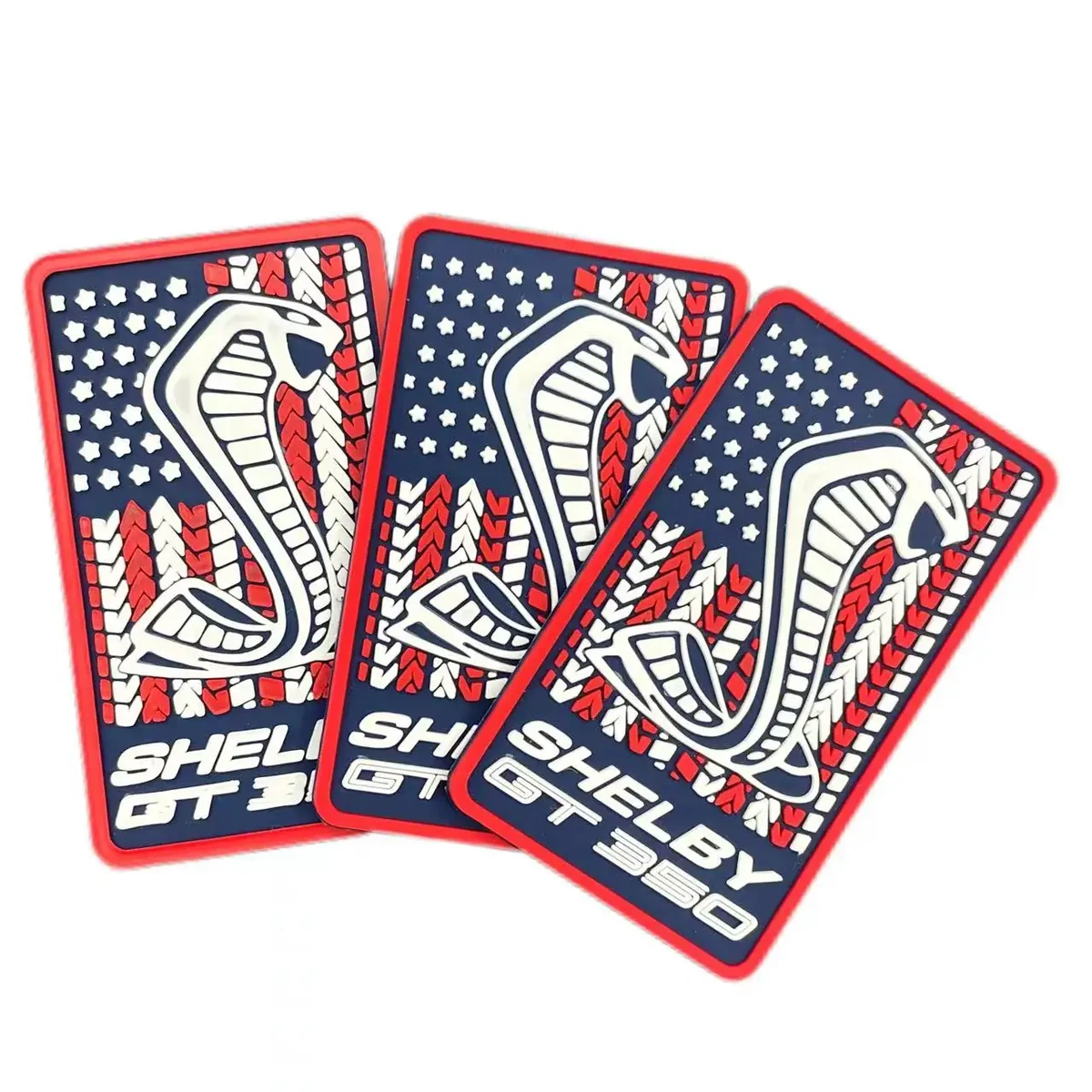 Custom red and navy PVC rubber patch set with raised car emblem detail