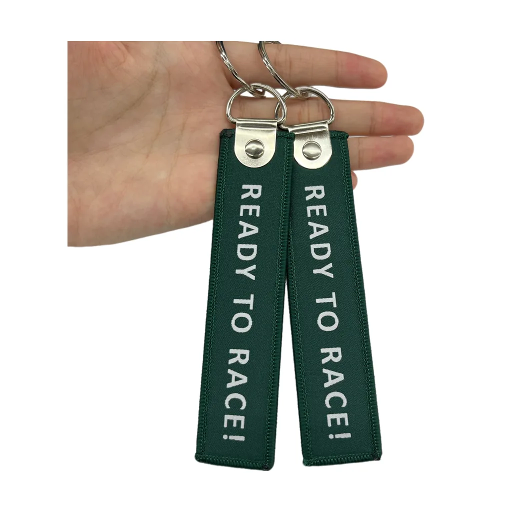 Custom woven fabric key tags held in hand with metal rings