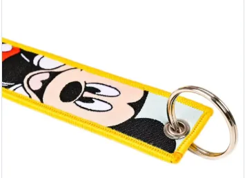 Close-up woven keychain with yellow border and metal ring
