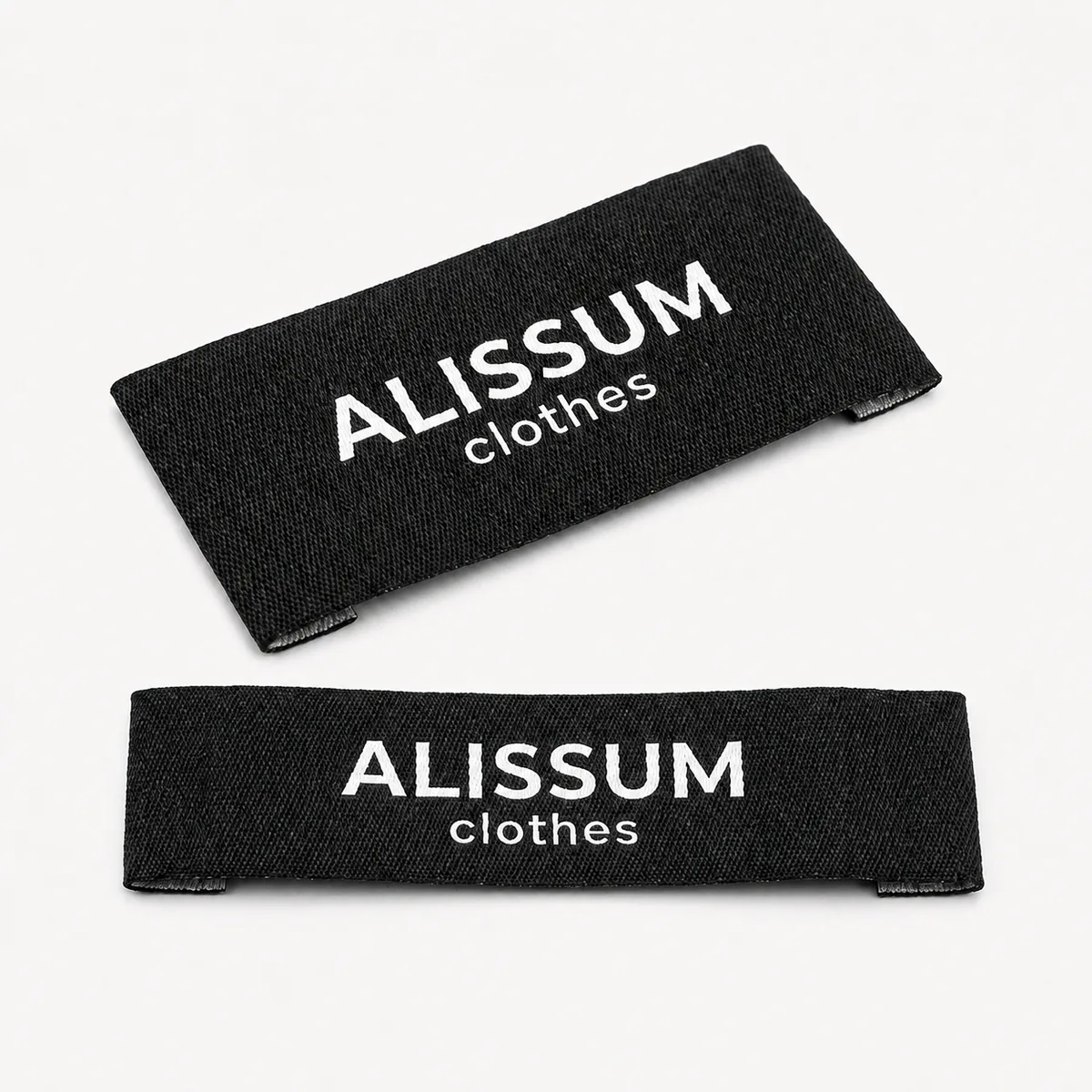 Custom woven Alissum clothes brand labels in black, end fold